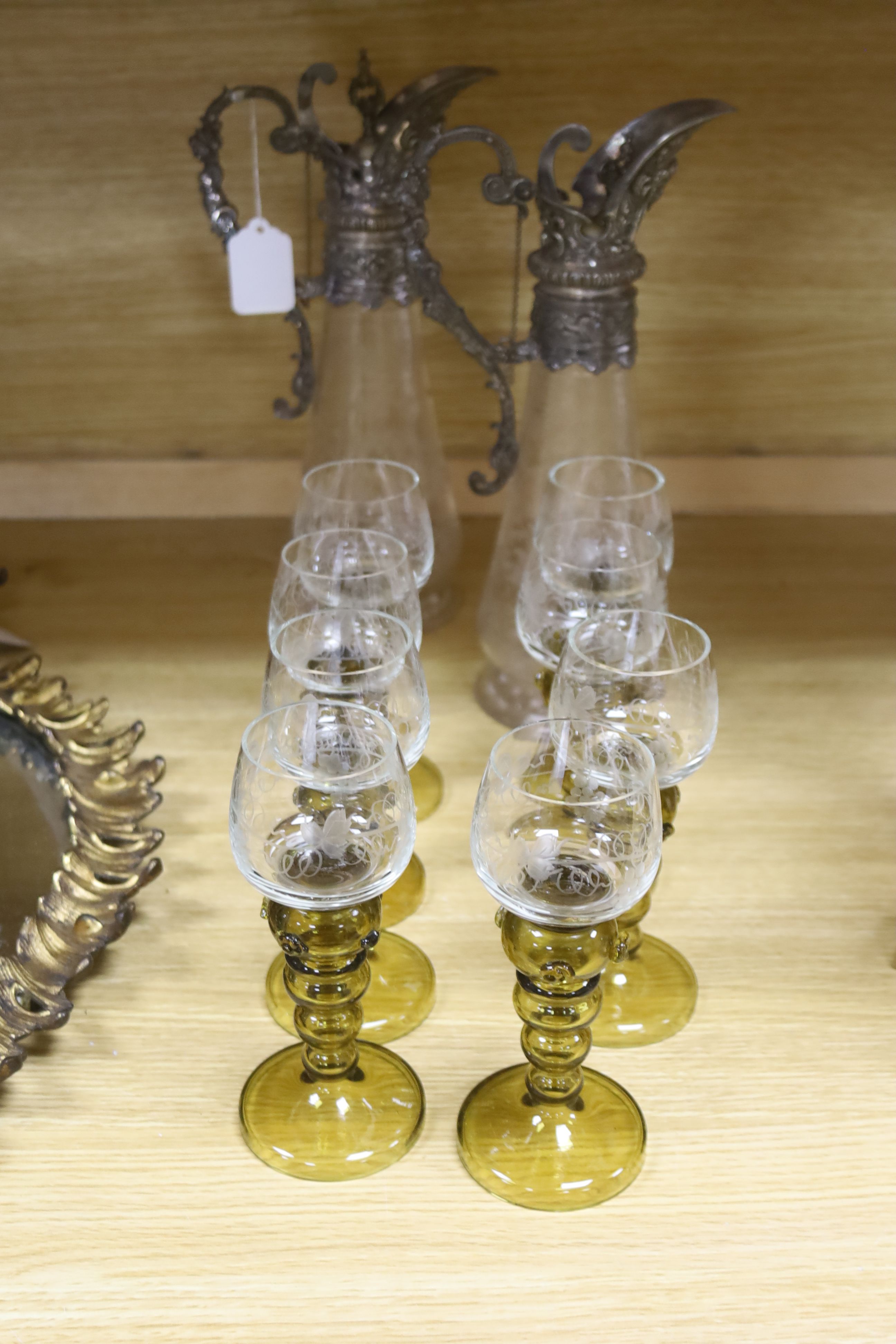 A pair of Victorian claret jugs and a set of eight green hock glasses